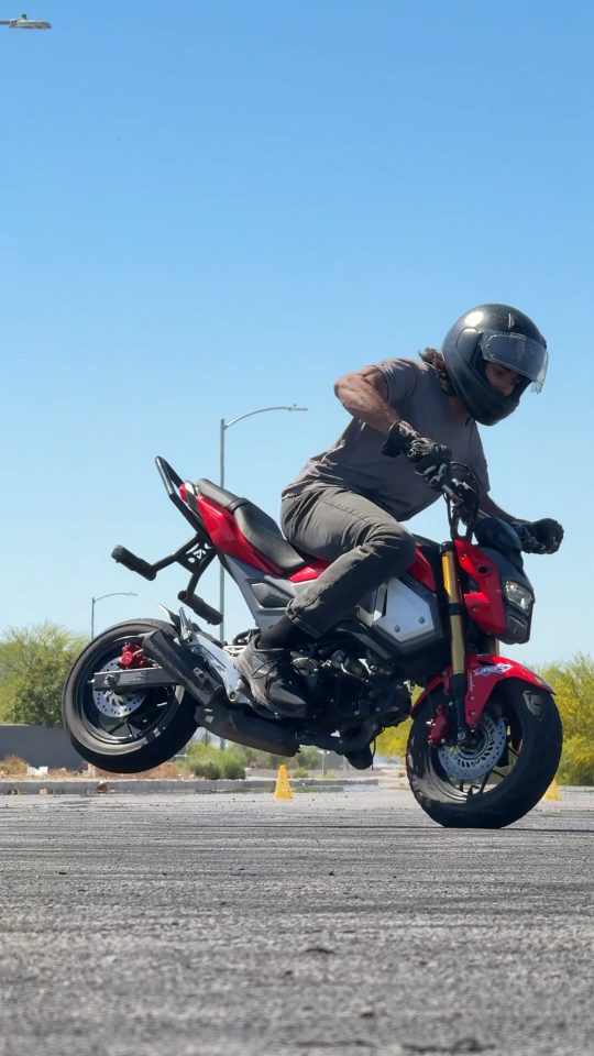 A Grom with AirTech holding a stoppie
