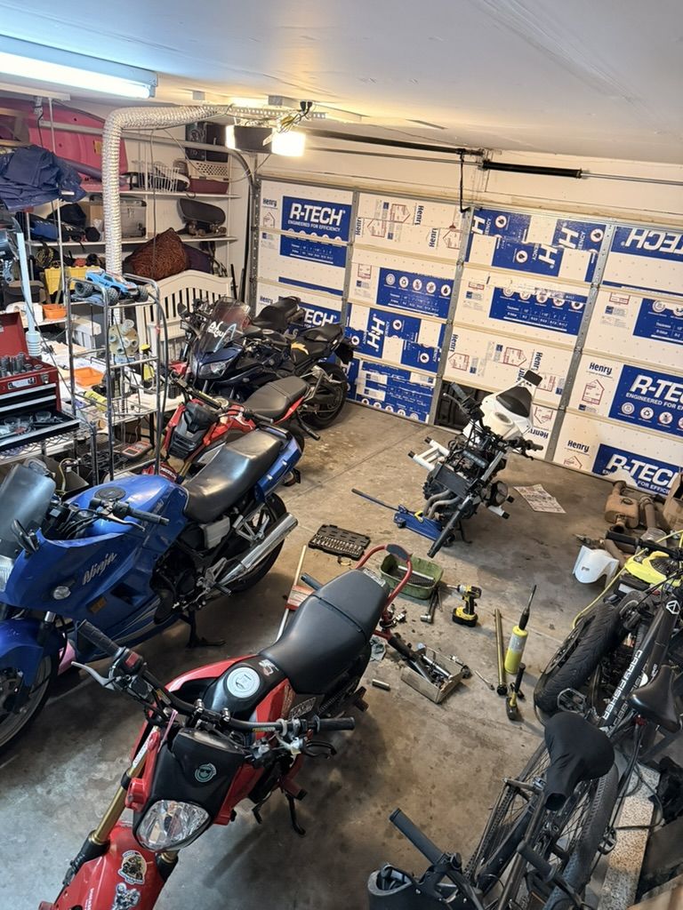 The Impulse Movement garage workshop with motorcycles, a bike stand and tools